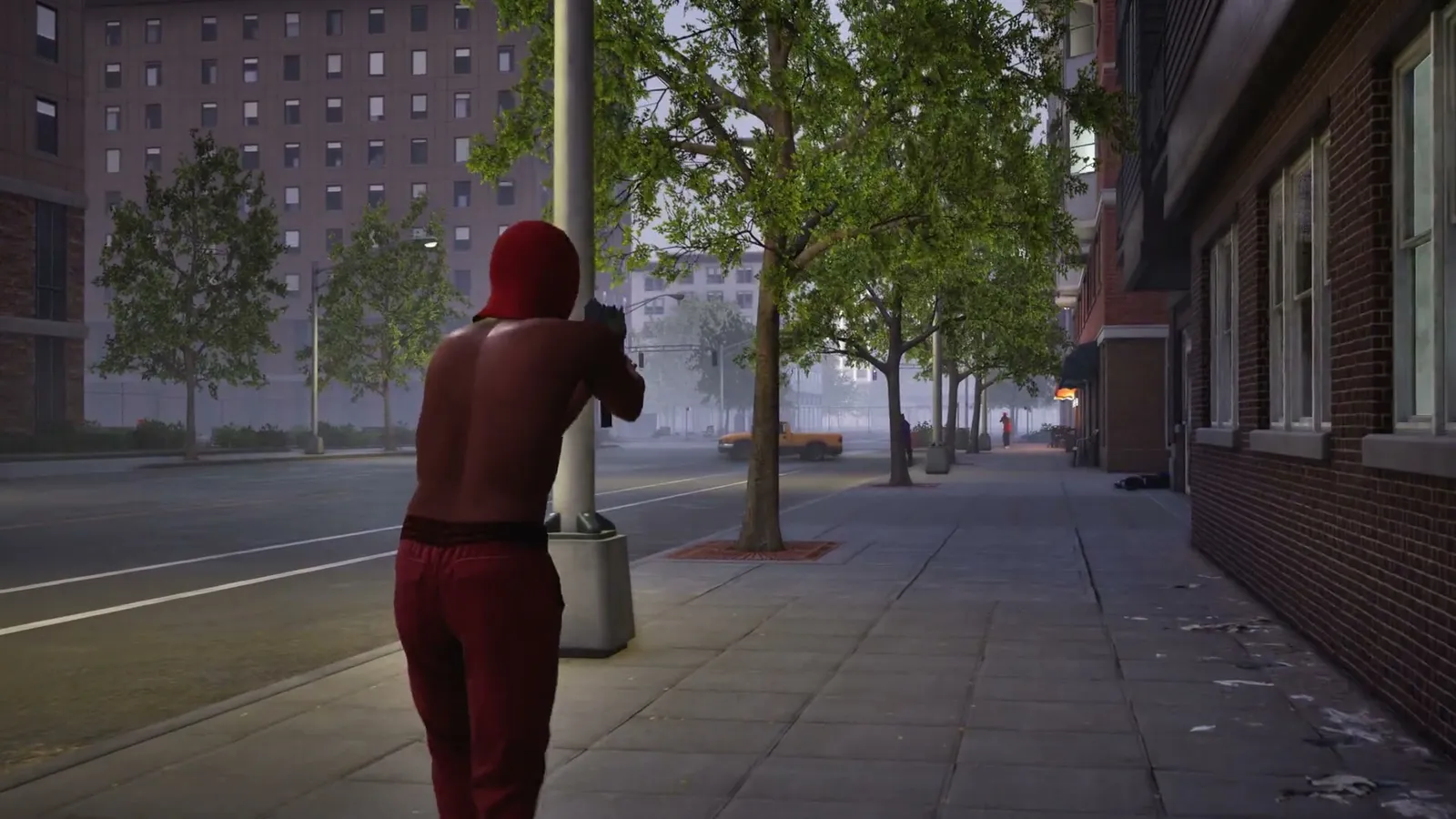 Red hooded player aiming down a tree lined sidewalk at dusk